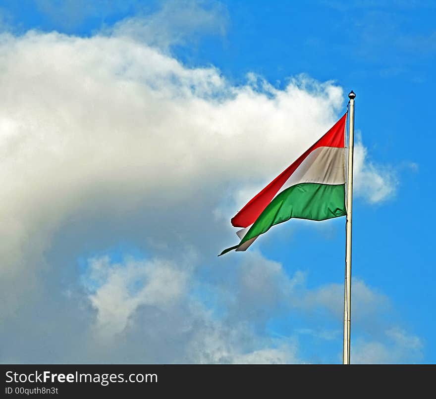 Photo of the flag at the cloudy sky background