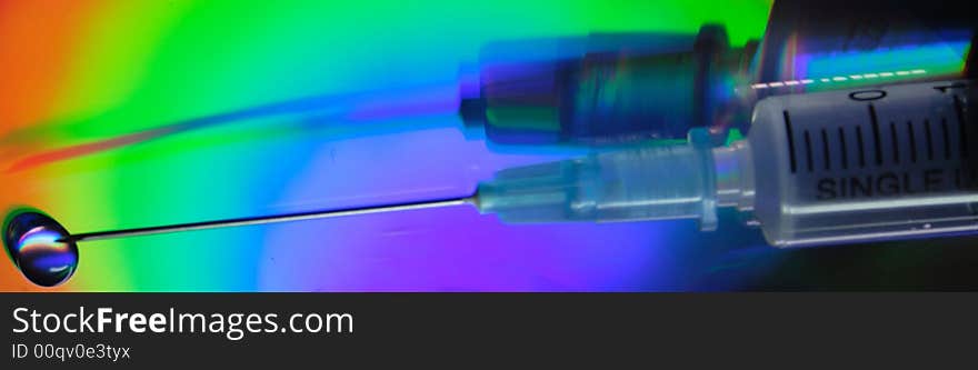 Syringe close up on an iridescent background of a reflecting surface