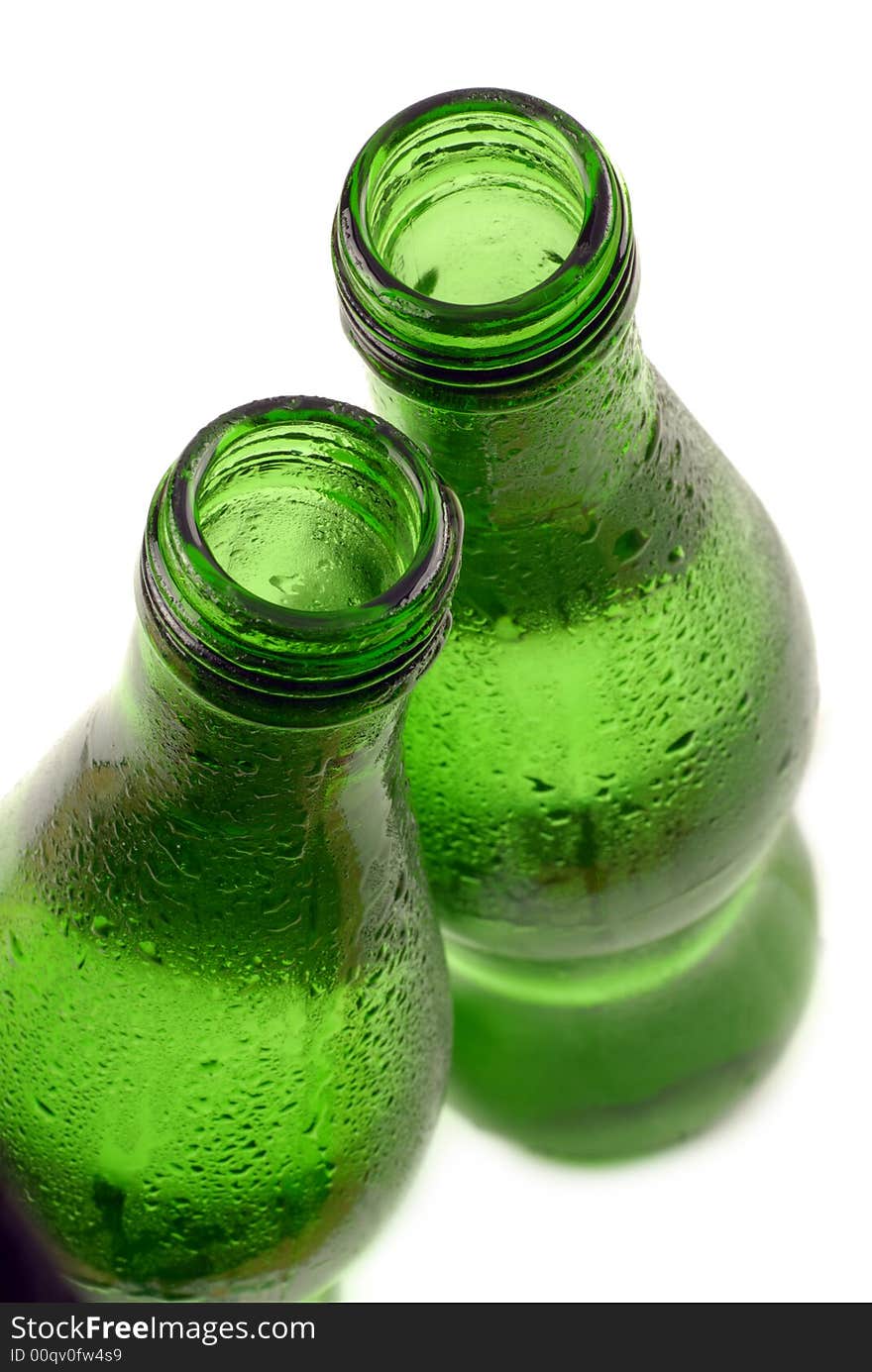 Bottled water in green, condensation-covered bottle; differential focus