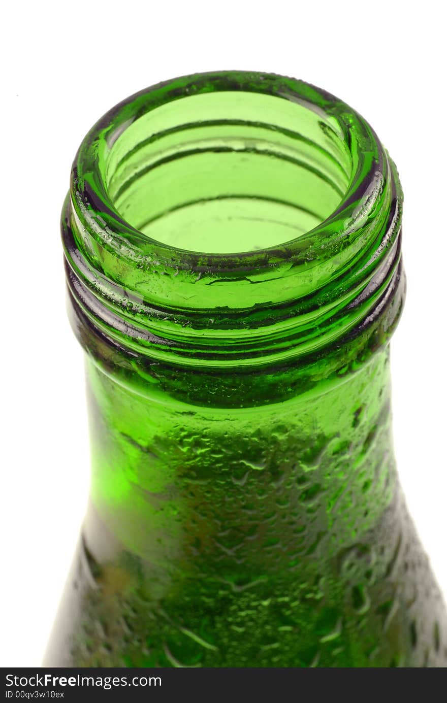 Bottled water in green, condensation-covered bottle; differential focus