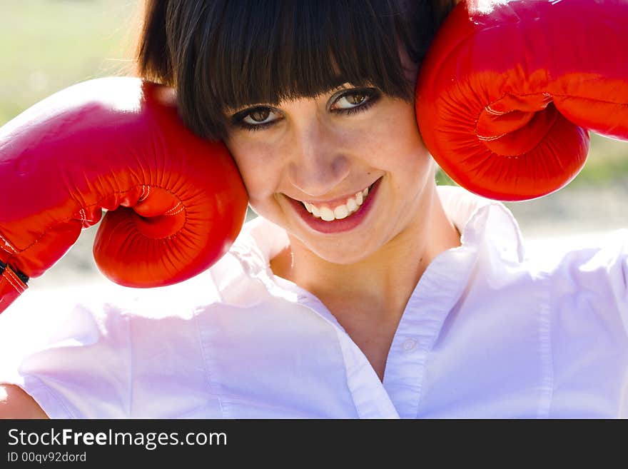 Smiling young girl fooling around with gloves