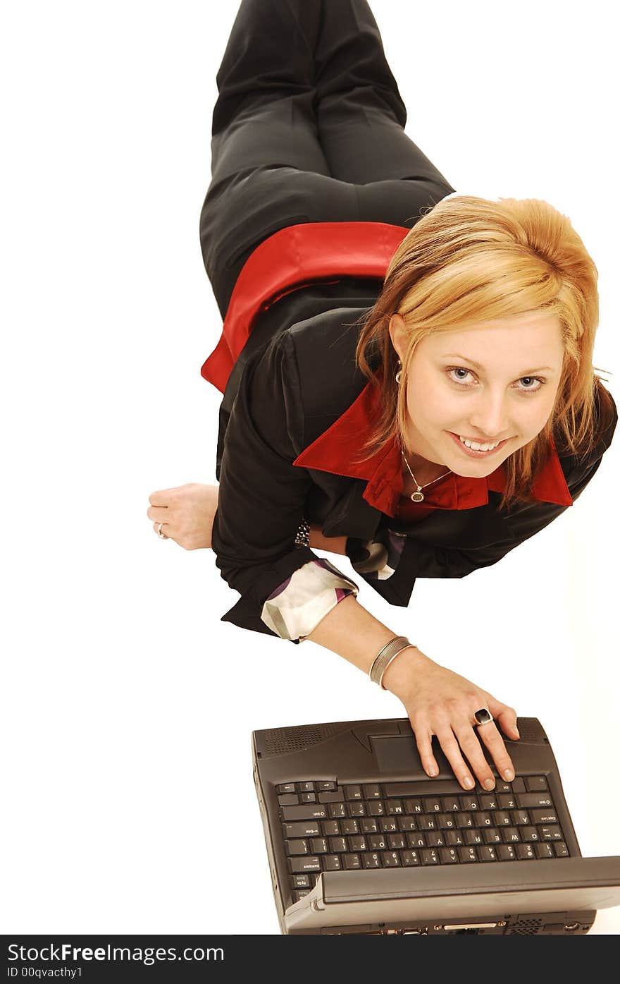 An pretty young lady lying on the floor and working on her laptop. An pretty young lady lying on the floor and working on her laptop.