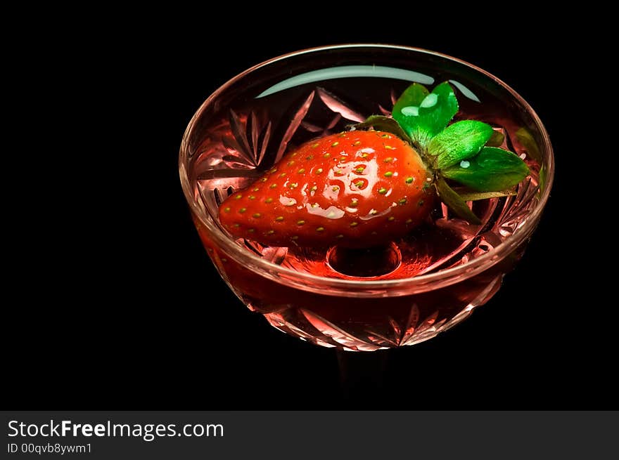 Strawberry in a drink on dark background. Strawberry in a drink on dark background