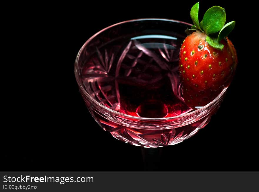 Strawberry in a drink on dark background. Strawberry in a drink on dark background