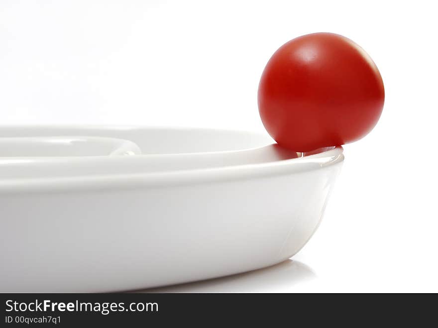 Tomato on a white plate. Tomato on a white plate