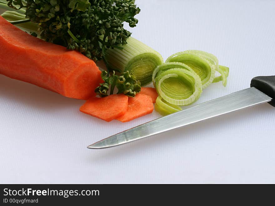 Freshly cut vegetables on cutting board for preparing a healthy soup. Freshly cut vegetables on cutting board for preparing a healthy soup