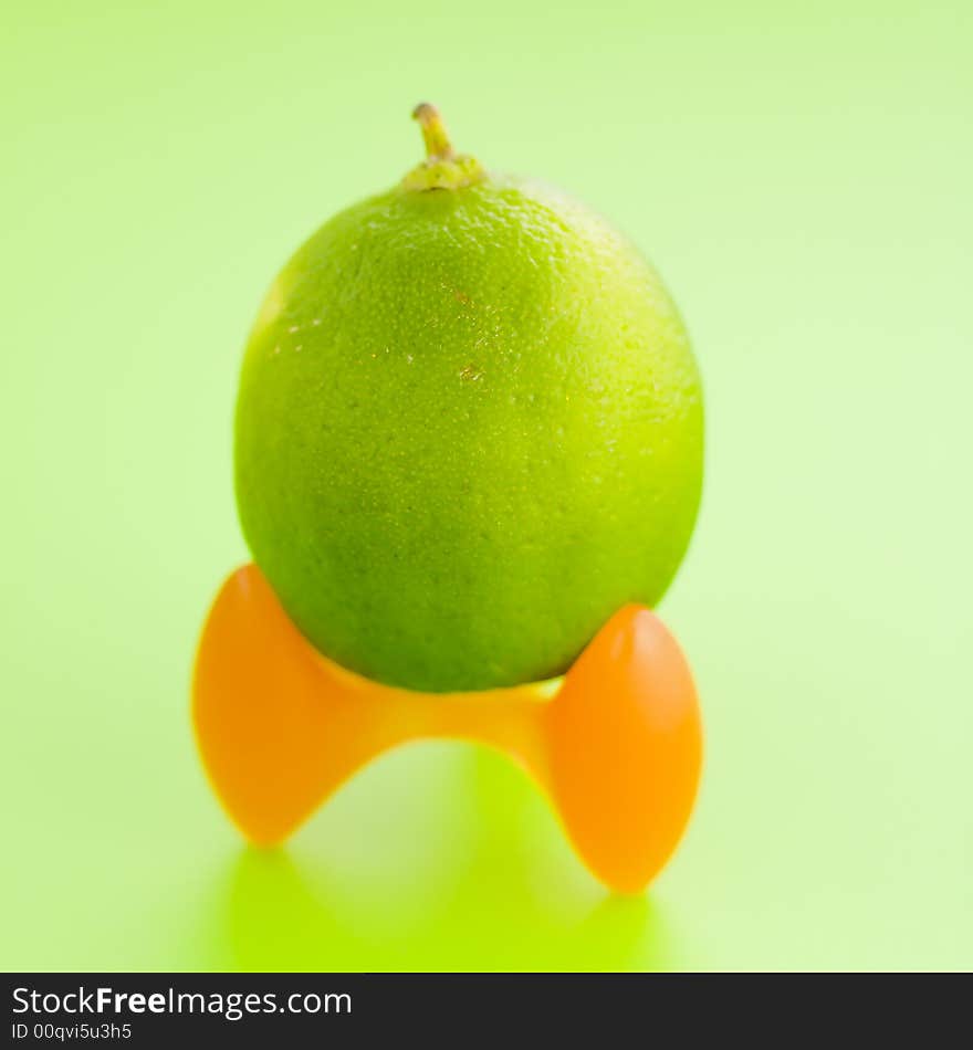 Lime top of the modern egg vase on the green background