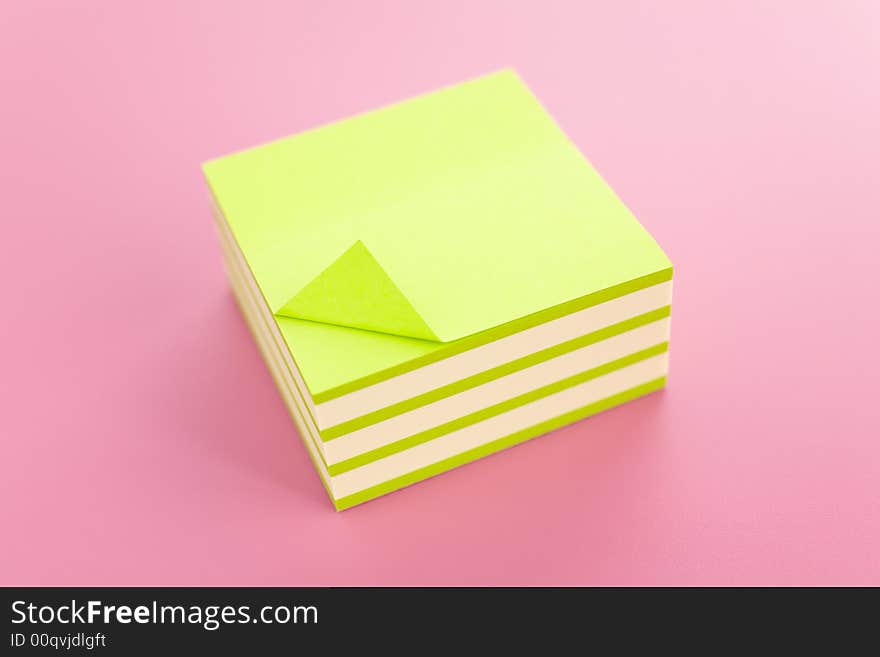 Pile of sticky notes over a pink table