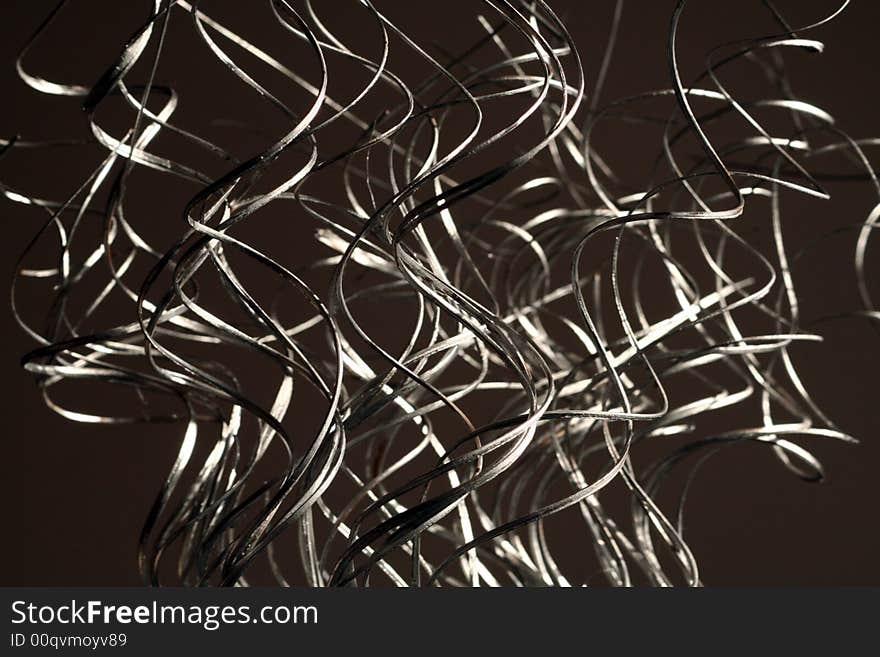 Silver swirling grass like decorations arranged in a vertical fashion. Silver swirling grass like decorations arranged in a vertical fashion.