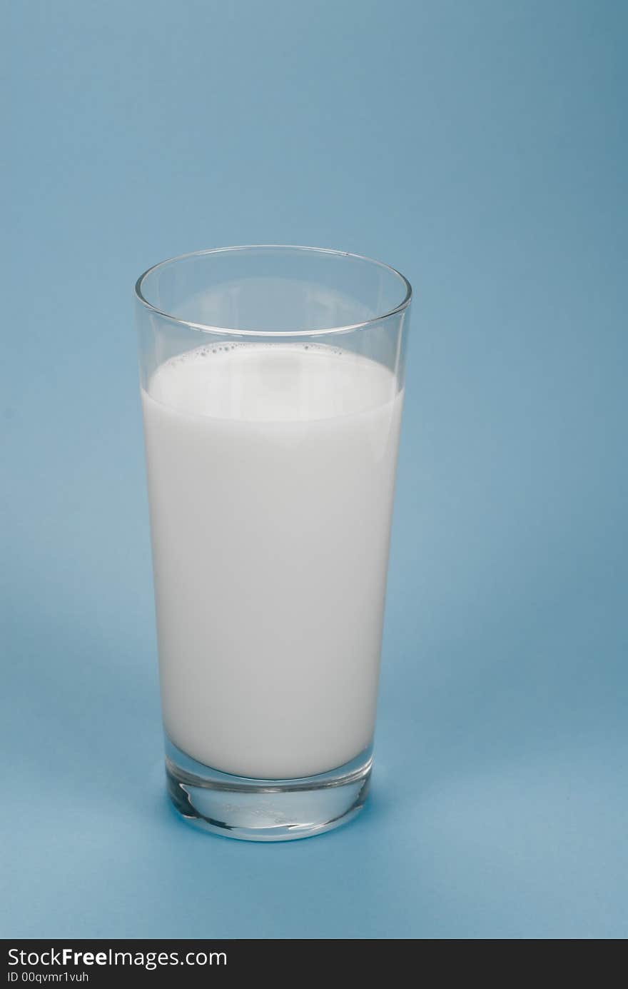 Glass of milk on a light-blue background