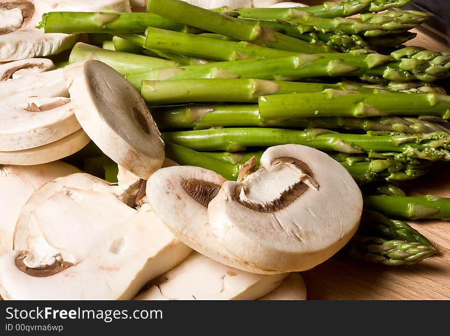 Fresh mushrooms and asparagus on a cutting board healthy. Fresh mushrooms and asparagus on a cutting board healthy