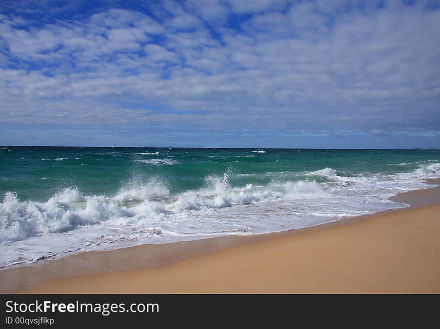 Paradise beach with a golden sand and cloudy sky