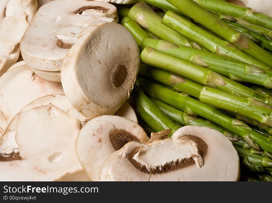 Fresh mushrooms and asparagus on a cutting board healthy. Fresh mushrooms and asparagus on a cutting board healthy