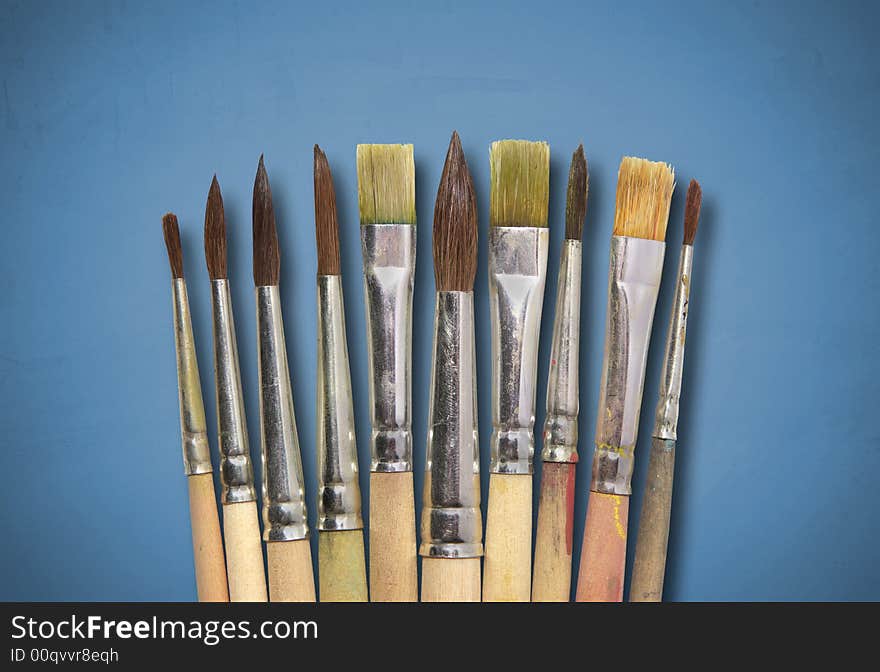 Collection of brushes on blue textured background