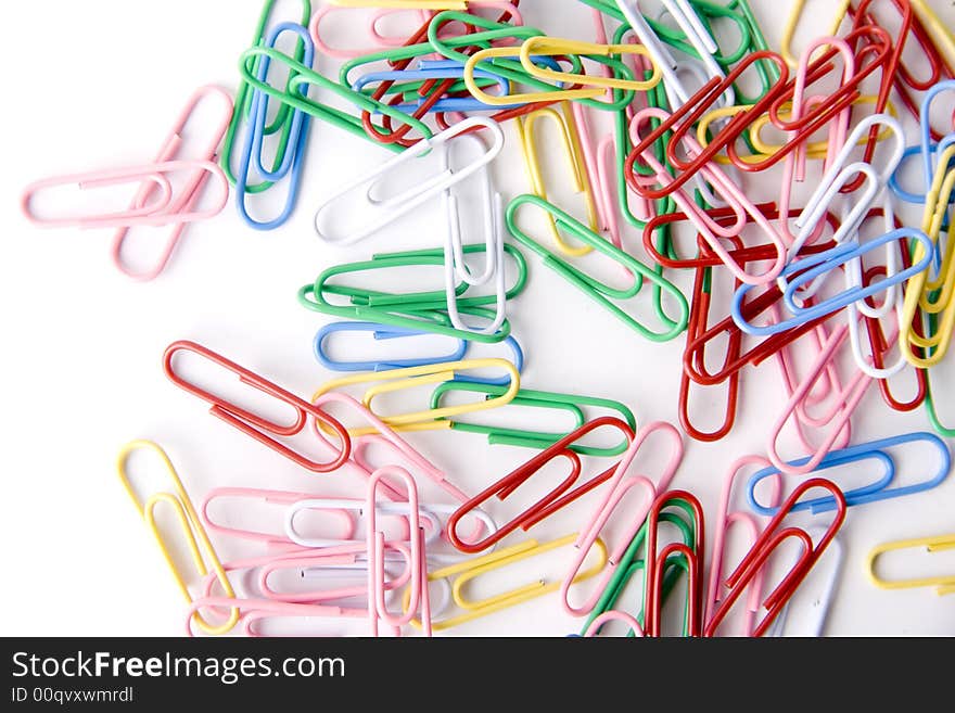 A lot of paper clips isolated on white