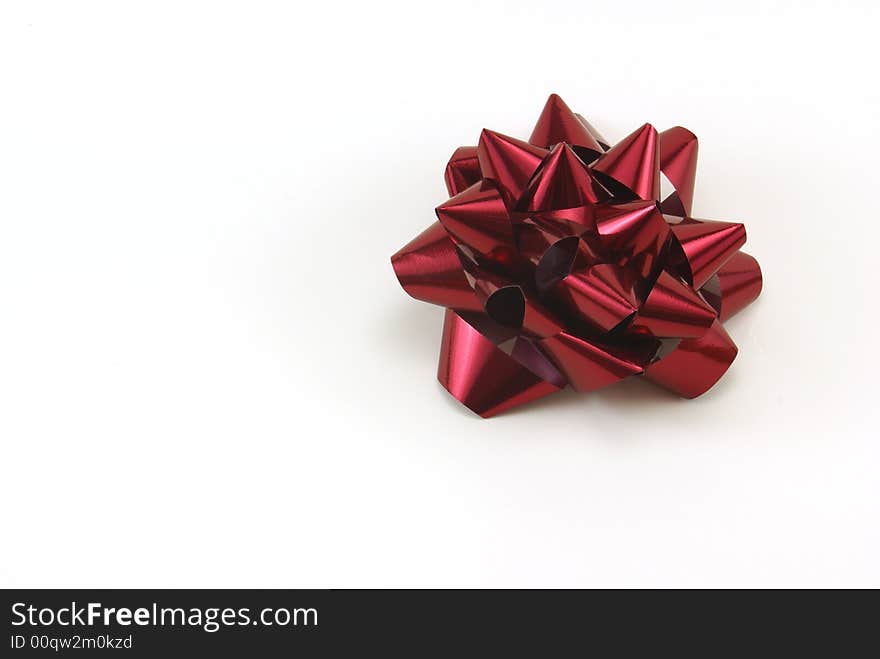 Deep red Christmas gift bow on white background. Deep red Christmas gift bow on white background.