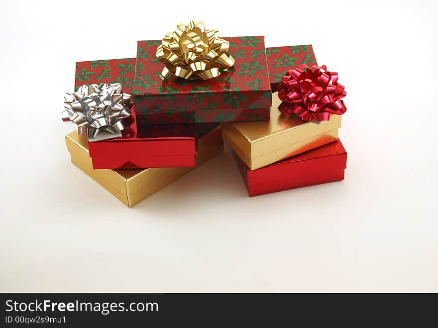 Christmas boxes, packages and presents with shiny bows on white background. Christmas boxes, packages and presents with shiny bows on white background.