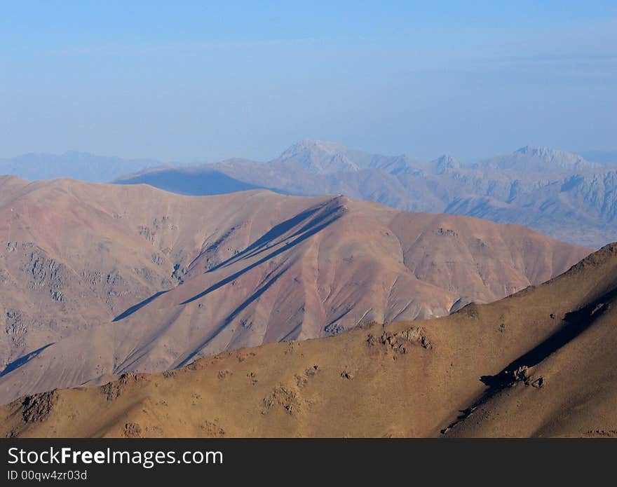 Pink mountain slopes on blue sky background. Pink mountain slopes on blue sky background