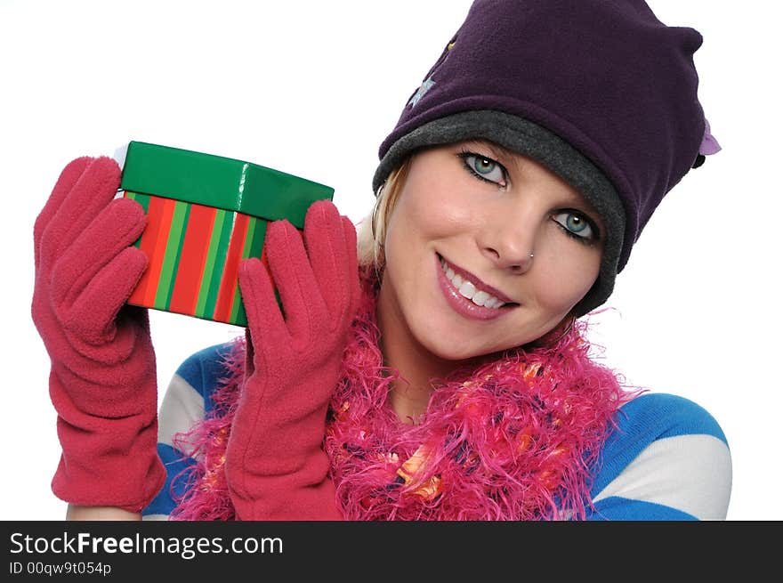 Gorgeous girl holding gift with winter clothes isolated on white