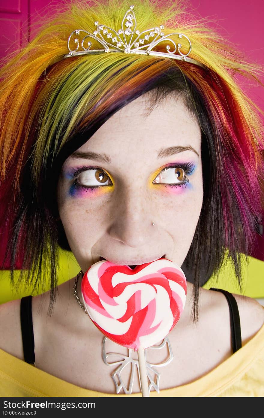 Alternative Girl in a Colorful Kitchen with a Heart Lollipop. Alternative Girl in a Colorful Kitchen with a Heart Lollipop