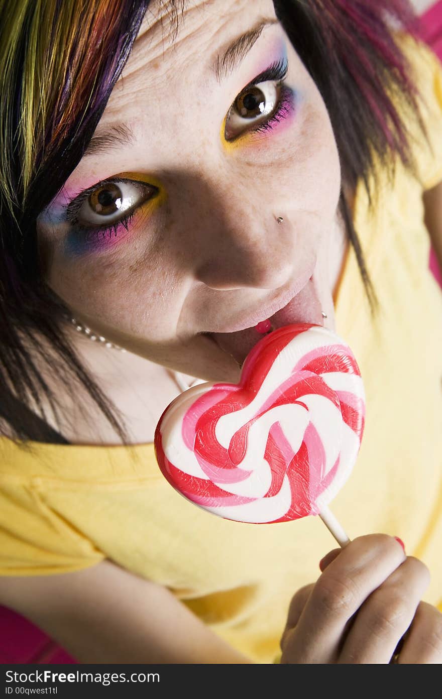 Close-up of an Alternative Girl with a Heart Lollipop