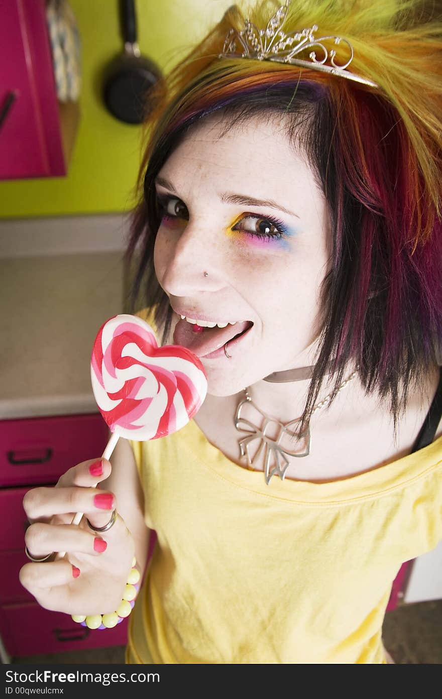 Alternative Girl in a Colorful Kitchen with a Heart Lollipop. Alternative Girl in a Colorful Kitchen with a Heart Lollipop