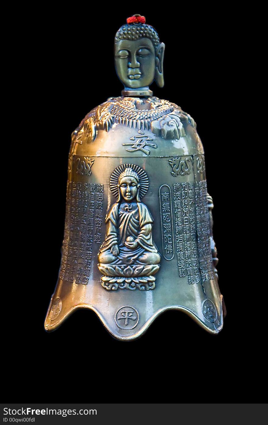 A bronze bell with Chinese characters and an image of Buddha sitting in the lotus position and the face of Buddha as handle, isolated on black. A bronze bell with Chinese characters and an image of Buddha sitting in the lotus position and the face of Buddha as handle, isolated on black