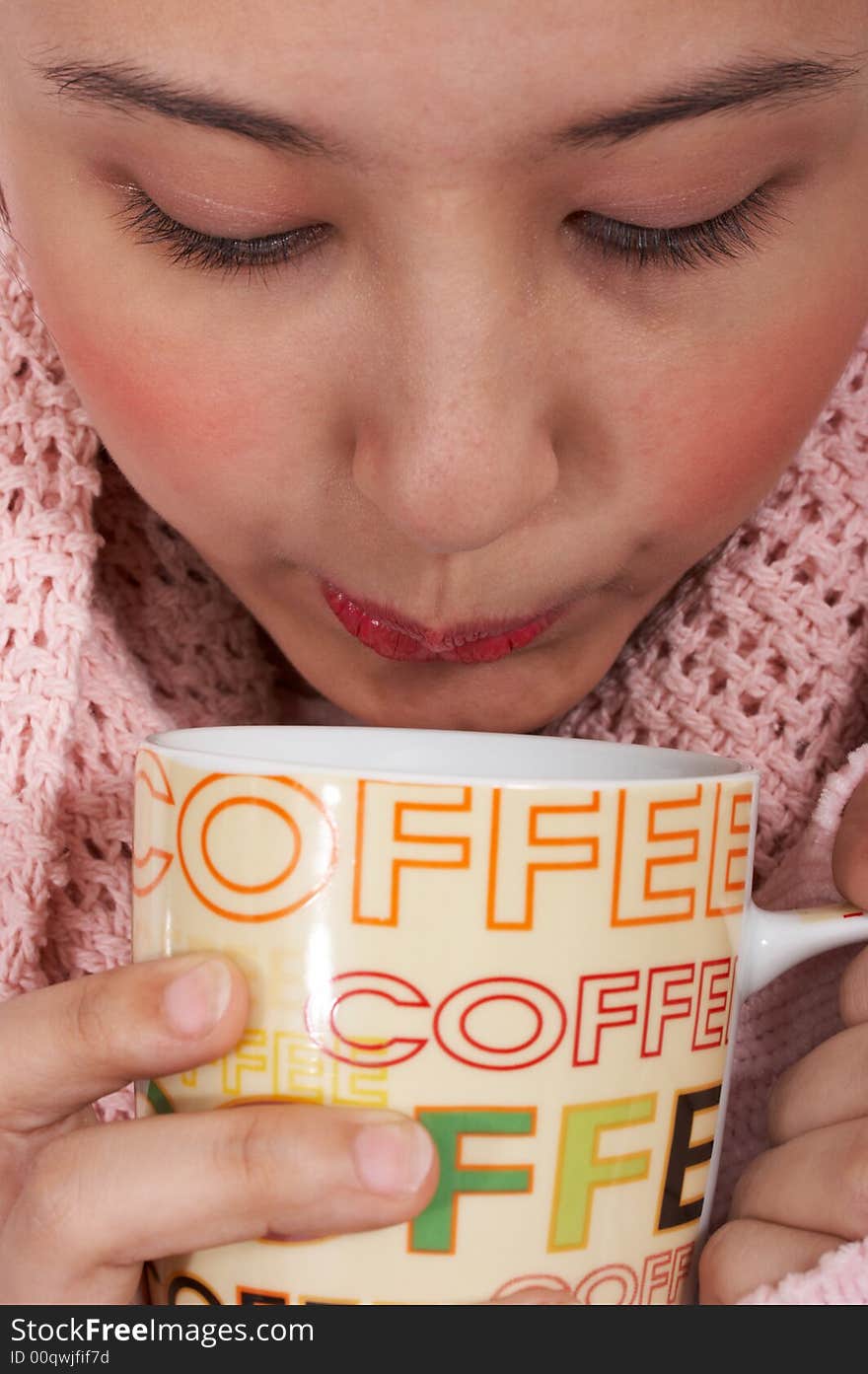 Young woman holding a cup of coffee