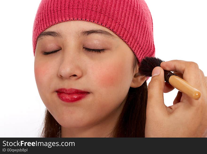 Winter lady putting make up on her cheek