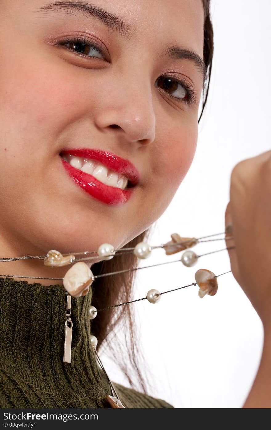 Pretty young girl wearing a white necklace