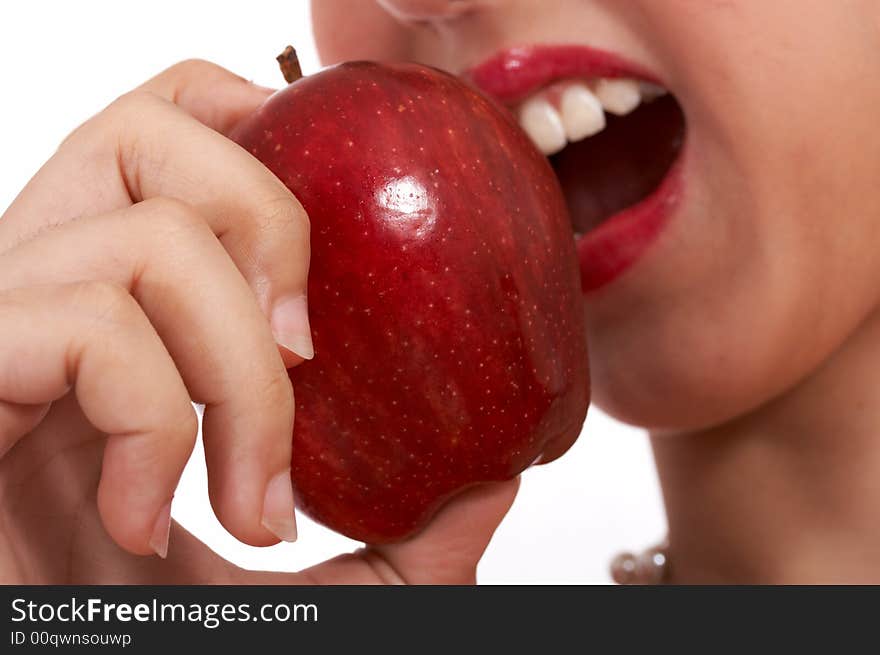 Young girl heaving a bite on a delicious and tasty red apple. Young girl heaving a bite on a delicious and tasty red apple