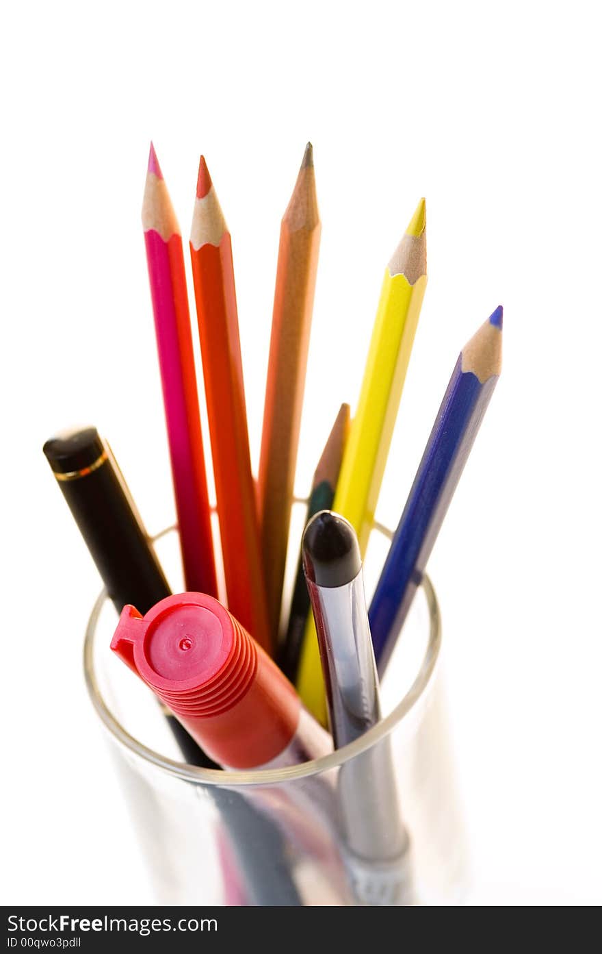 Pencils with a glass on the white background