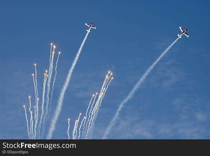 Two plane drop a fireworks display during their maneuver at the Al Ain Aerobatic Show. Two plane drop a fireworks display during their maneuver at the Al Ain Aerobatic Show.