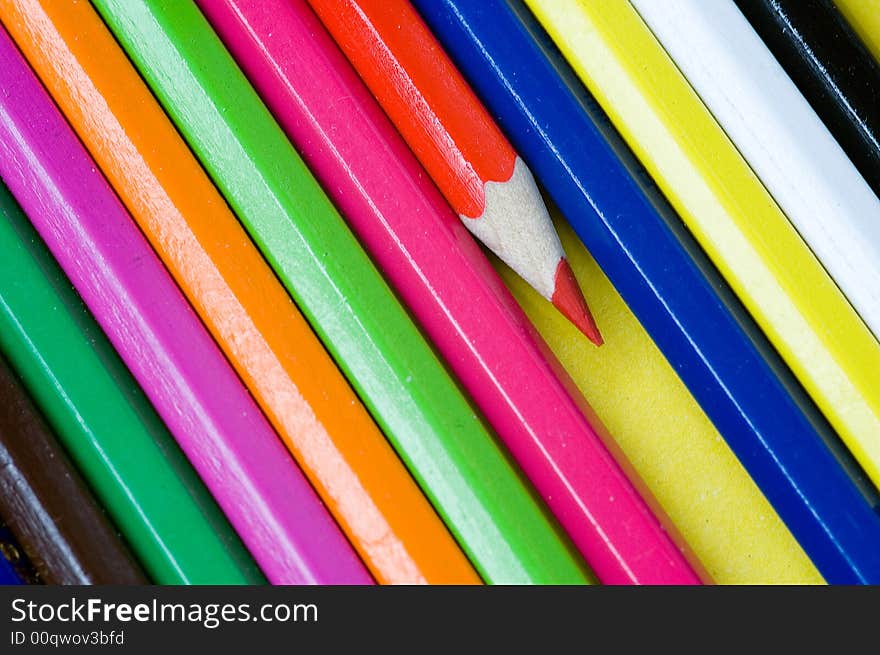 Red pencil crayon isolated from other colorful pencil crayons. Red pencil crayon isolated from other colorful pencil crayons