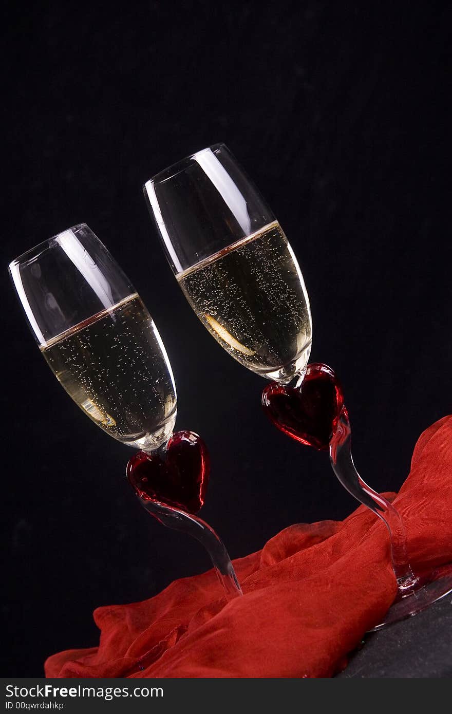 Two wineglasses with white sparkling wine, romantic table setting. Two wineglasses with white sparkling wine, romantic table setting.