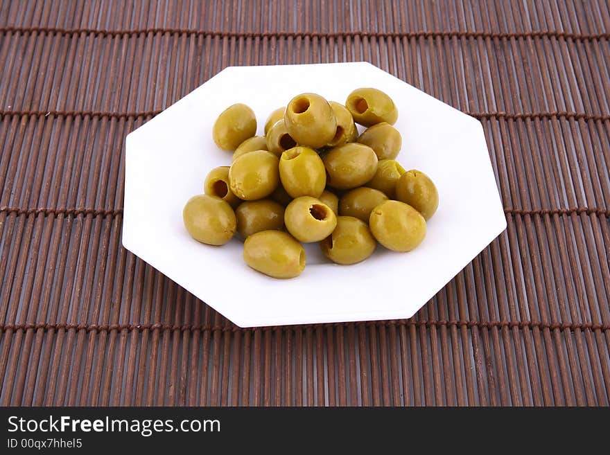 A small bowl of olives on a table