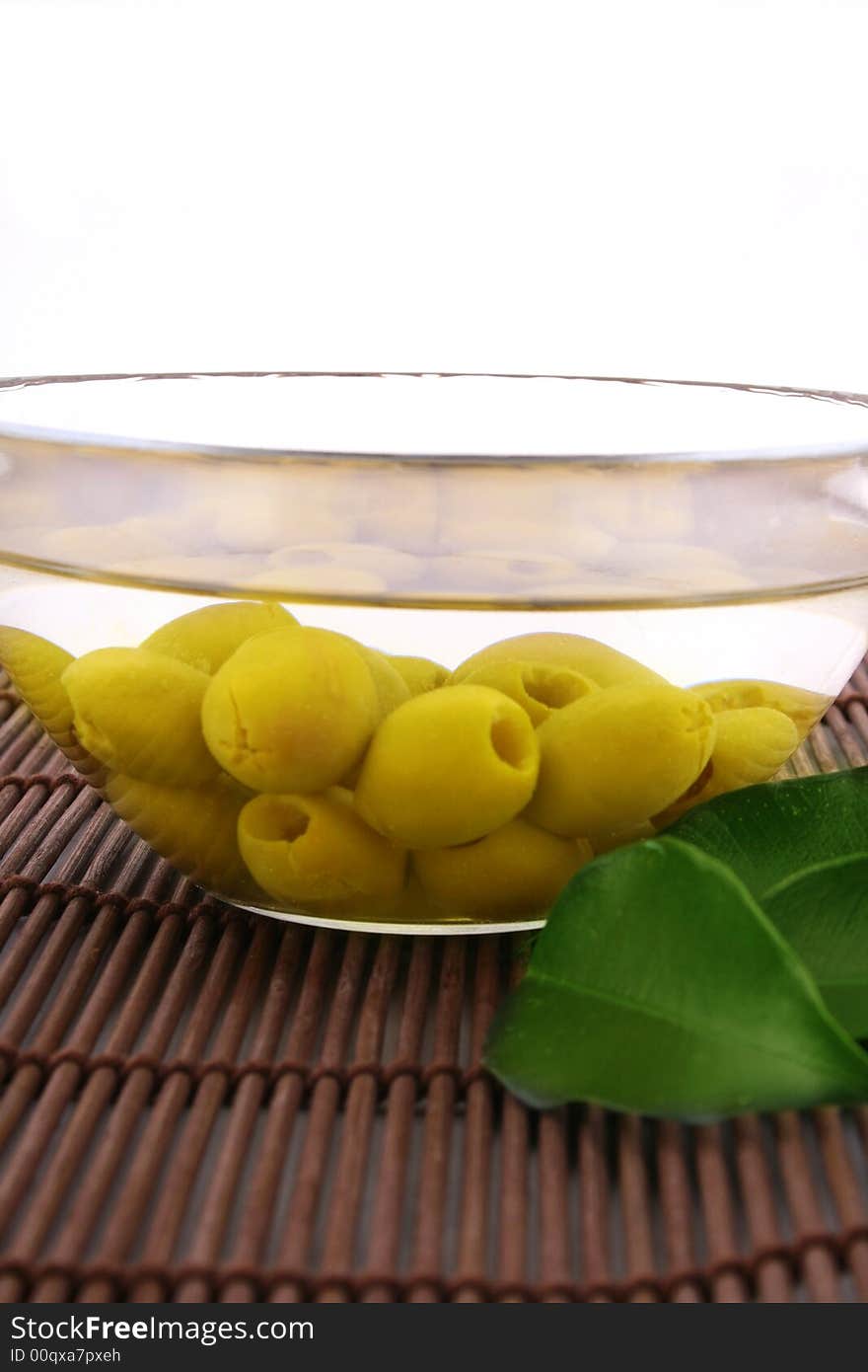 A small bowl of olives on a table