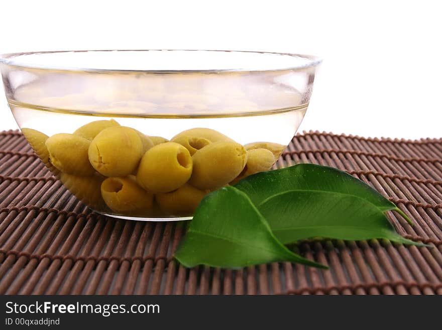 A small bowl of olives on a table