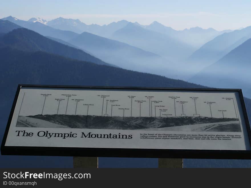 A view of the Olympic Mountains along with the national park sign. A view of the Olympic Mountains along with the national park sign