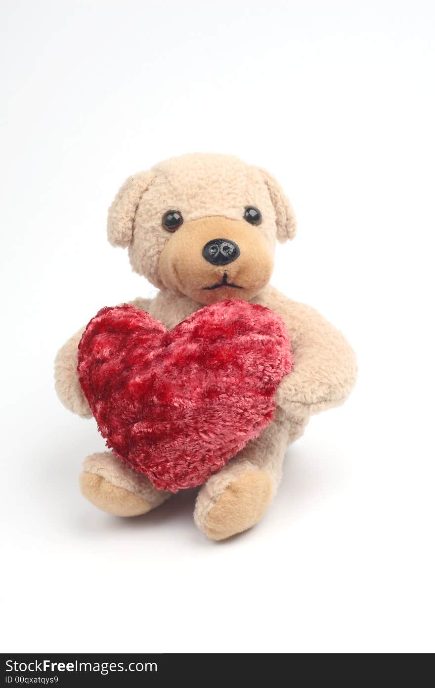 Teddy bear with red heart on white