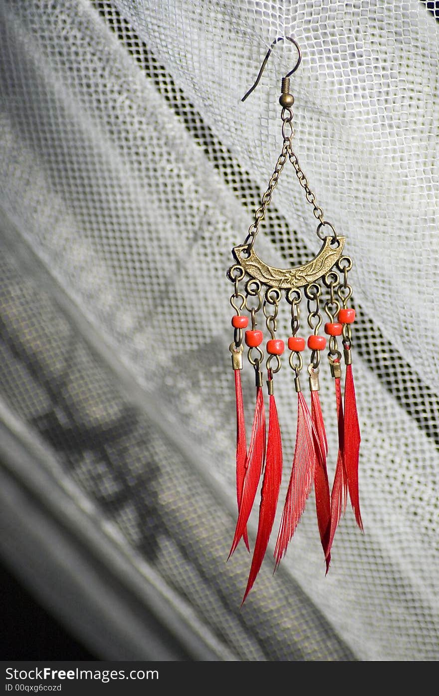 Red earring with feather