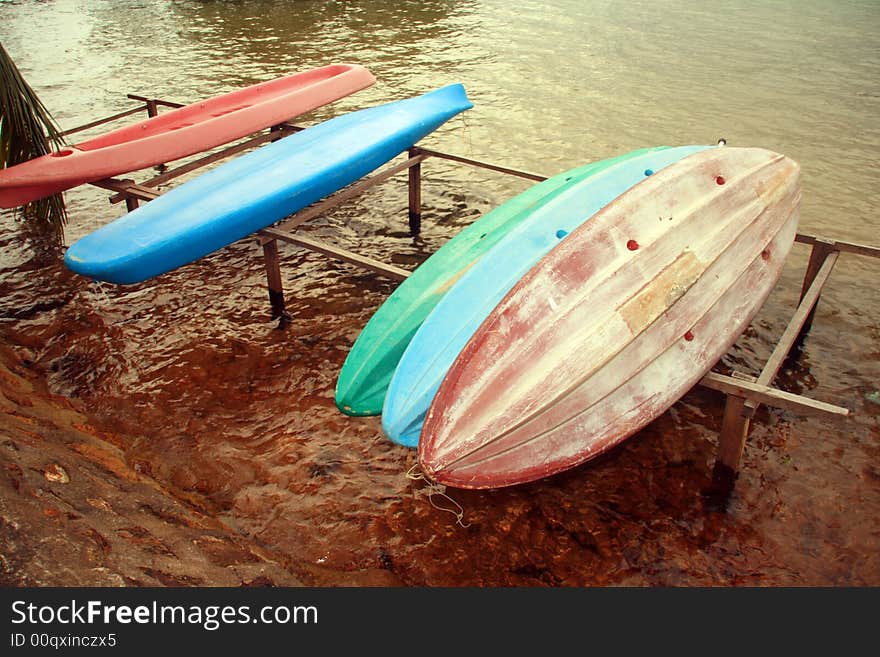 A bunch of plastic canoes for rent on a nearby beach resort