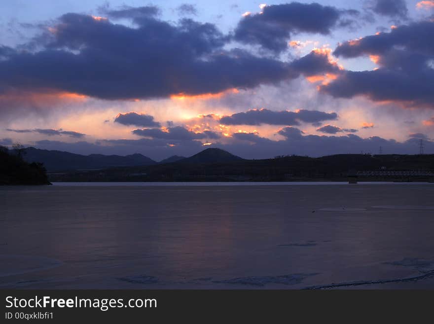 Sunset clouds and freezen water