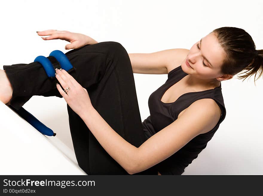 Woman is binding weights on her leg