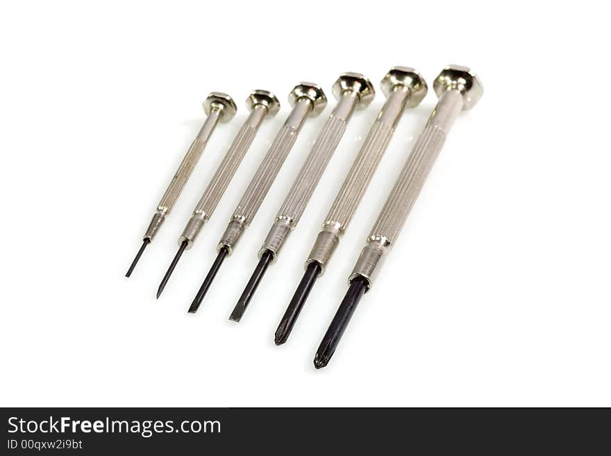 Metal Screw Driver in a row on bright Background. Metal Screw Driver in a row on bright Background