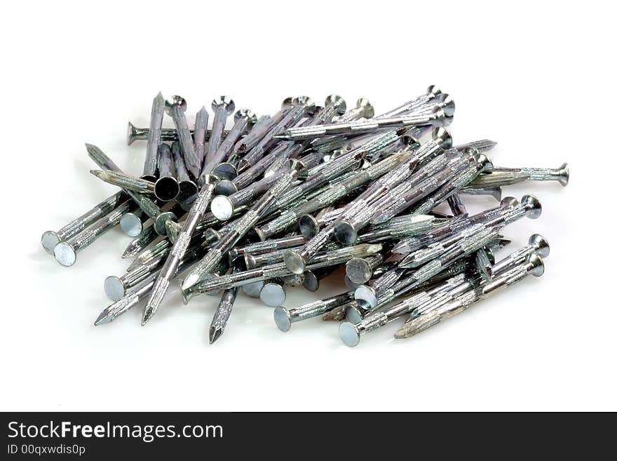 Pile of metal nails on bright Backkground