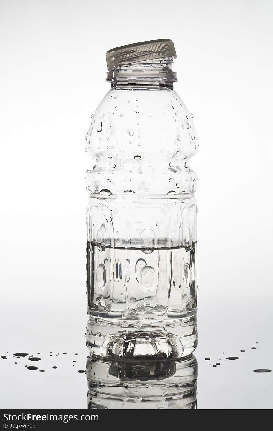 Half empty water bottle with water droplets. Half empty water bottle with water droplets