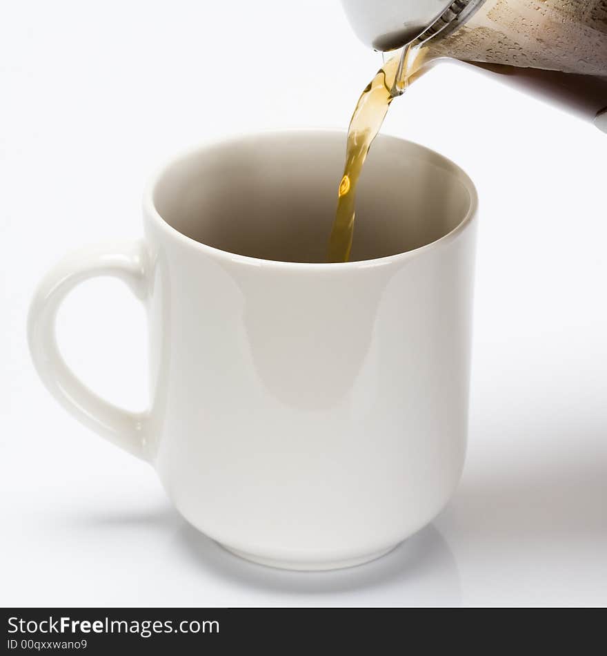 French press made coffe being poured into coffe cup. French press made coffe being poured into coffe cup