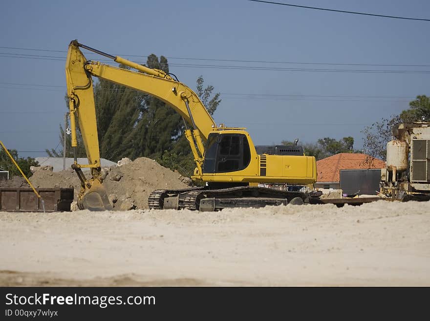 A backhoe sits Idle during the lunch break. A backhoe sits Idle during the lunch break