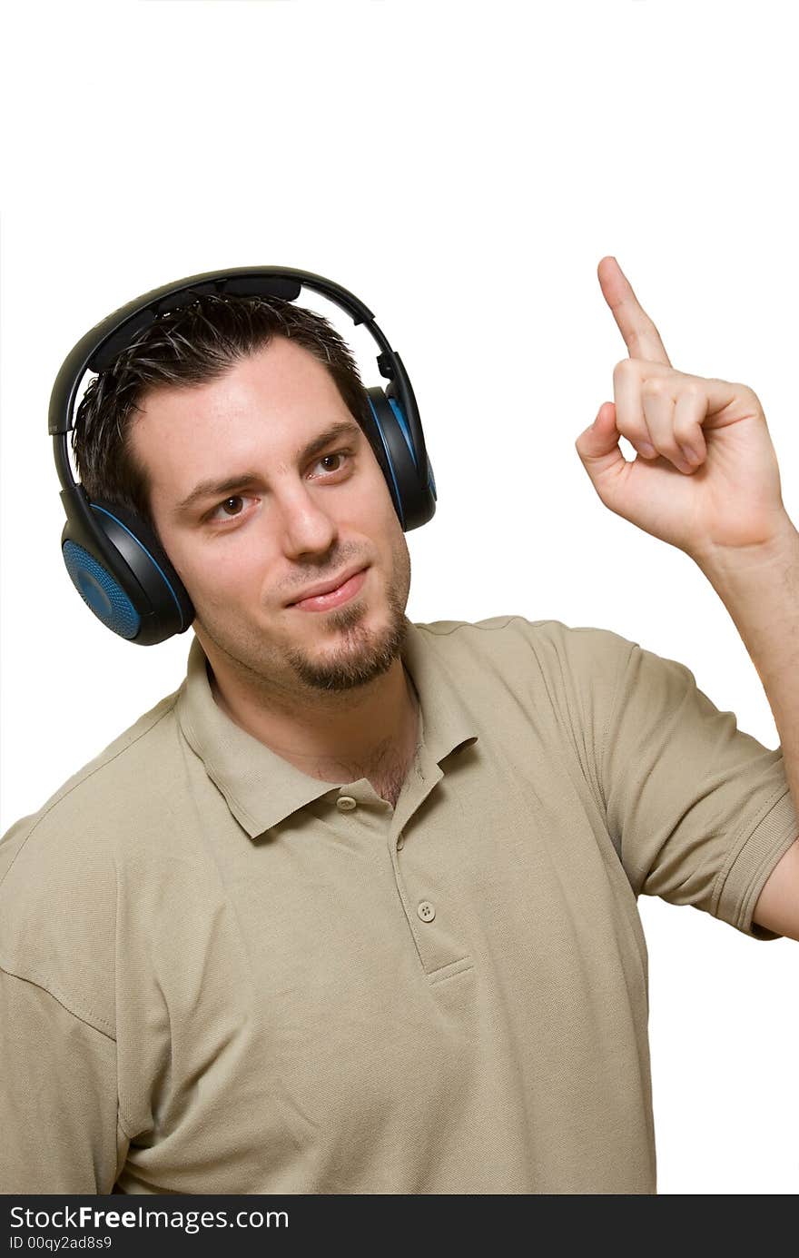 A man, wearing headphones, listening to some music, pointing his finger up. A man, wearing headphones, listening to some music, pointing his finger up